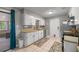 Bright kitchen featuring white cabinets, tile flooring, and stainless appliances at 1107 Valley Rd, Fruitland Park, FL 34731