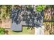 Aerial view of a home with a grey shingled roof and mature tree coverage at 1107 Valley Rd, Fruitland Park, FL 34731