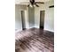 Spacious bedroom with wood grain flooring, ceiling fan, and closet at 11252 Country Haven Dr, Lakeland, FL 33809
