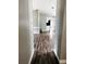 Hallway view with dark floors and connecting rooms, showing the home's layout at 11252 Country Haven Dr, Lakeland, FL 33809