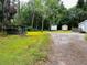 View of the property with sheds, parking area, and wooden structure at 11252 Country Haven Dr, Lakeland, FL 33809