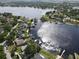 Aerial view of a neighborhood on canals and a lake, showcasing waterfront living with boat access at 11312 Haskell Dr, Clermont, FL 34711