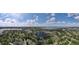 Panoramic aerial showcasing a vibrant community nestled around a lake, adorned with lush greenery at 11312 Haskell Dr, Clermont, FL 34711