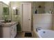 Bathroom featuring a tub with shower, a vanity with sink, and tiled floors at 11312 Haskell Dr, Clermont, FL 34711