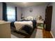 Cozy bedroom with blue bedding, natural light, and stylish decor at 11312 Haskell Dr, Clermont, FL 34711