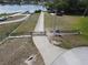 Community boat ramp and docks on a lake with neighborhood homes visible across the water at 11312 Haskell Dr, Clermont, FL 34711
