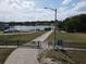 Community boat ramp and docks on a lake with neighborhood homes visible across the water at 11312 Haskell Dr, Clermont, FL 34711