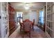 Inviting dining room featuring a rustic hutch, elegant table set, and sunlit view into the kitchen at 11312 Haskell Dr, Clermont, FL 34711