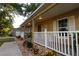 Inviting front porch with decorative railings, charming details, and manicured landscaping leading to the entrance at 11312 Haskell Dr, Clermont, FL 34711