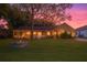 Charming home exterior featuring a manicured lawn, lovely garden bed, and inviting front porch at 11312 Haskell Dr, Clermont, FL 34711