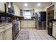 Well-appointed kitchen with stainless steel appliances, tiled flooring, and bright cabinetry offering ample storage and functionality at 11312 Haskell Dr, Clermont, FL 34711