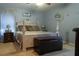 Comfortable main bedroom with a decorative four-poster bed, soft lighting, and neutral decor at 11312 Haskell Dr, Clermont, FL 34711
