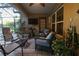 Relaxing covered patio with comfortable seating and lush greenery, perfect for outdoor living at 11312 Haskell Dr, Clermont, FL 34711
