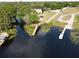 Aerial view of private docks on canals leading to a lake, lily pads visible in the foreground at 11312 Haskell Dr, Clermont, FL 34711