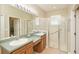 Spacious bathroom with double sinks and large glass enclosed shower at 117 Falling Acorn Ave, Groveland, FL 34736