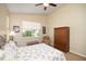 Comfortable bedroom featuring a ceiling fan and natural light at 117 Falling Acorn Ave, Groveland, FL 34736