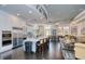 Spacious community kitchen boasts stainless steel appliances, an island bar, and comfortable seating areas nearby at 117 Falling Acorn Ave, Groveland, FL 34736