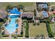 Aerial view of a luxurious community pool featuring sunshades and lounge chairs at 117 Falling Acorn Ave, Groveland, FL 34736