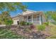 Charming single-story home featuring a cozy front porch and beautiful landscaping at 117 Falling Acorn Ave, Groveland, FL 34736