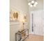 Elegant foyer featuring stylish decor, a glass table and neutral wall colors at 117 Falling Acorn Ave, Groveland, FL 34736