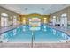 Bright indoor pool area features a volleyball net and offers a great space for recreation and relaxation at 117 Falling Acorn Ave, Groveland, FL 34736