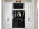 Modern kitchen with a black refrigerator and built in storage cabinets at 117 Falling Acorn Ave, Groveland, FL 34736