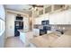 Bright kitchen with island, modern appliances, countertops, and plenty of cabinet space at 117 Falling Acorn Ave, Groveland, FL 34736
