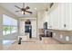 Bright kitchen featuring stainless steel appliances and light-colored cabinetry at 117 Falling Acorn Ave, Groveland, FL 34736
