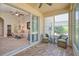 Relaxing lanai with comfortable seating and views into the living room and backyard at 117 Falling Acorn Ave, Groveland, FL 34736
