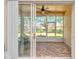 Enclosed lanai featuring tiled floors, ample seating and a view of the landscaped backyard at 117 Falling Acorn Ave, Groveland, FL 34736