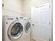 Modern laundry room featuring a front loading washer and dryer set at 117 Falling Acorn Ave, Groveland, FL 34736