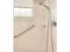 Accessible shower with grab bar, ensuring a safe and convenient bathing experience at 117 Falling Acorn Ave, Groveland, FL 34736