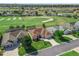 Aerial view of a residential neighborhood with homes situated around a golf course and mature trees at 12136 Se 176Th Loop, Summerfield, FL 34491