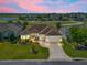 Expansive home boasts professional landscaping, a spacious driveway, and a well-maintained lawn at 12136 Se 176Th Loop, Summerfield, FL 34491