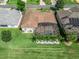 Aerial view of a property with screened-in pool, mature landscaping, and an adjacent golf course at 12136 Se 176Th Loop, Summerfield, FL 34491