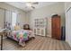 Bedroom with ceiling fan, wood floor, and closet at 12136 Se 176Th Loop, Summerfield, FL 34491