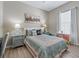 Bright bedroom with a floral bedspread, neutral walls, and a window offering natural light at 12136 Se 176Th Loop, Summerfield, FL 34491