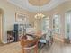 Elegant dining room featuring a unique wood table, crown molding, and plenty of natural light at 12136 Se 176Th Loop, Summerfield, FL 34491