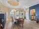 Elegant dining room featuring a unique wood table, crown molding, and plenty of natural light at 12136 Se 176Th Loop, Summerfield, FL 34491