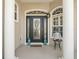 Elegant front door with decorative glass, sidelights, and a charming front porch decor at 12136 Se 176Th Loop, Summerfield, FL 34491