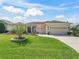 Charming home featuring a well-manicured lawn and inviting curb appeal with a two-car garage at 12136 Se 176Th Loop, Summerfield, FL 34491