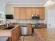 Kitchen featuring stainless steel appliances and granite countertops at 12136 Se 176Th Loop, Summerfield, FL 34491