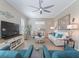 Bright living room featuring neutral walls, modern furniture, and a decorative ceiling fan for a welcoming atmosphere at 12136 Se 176Th Loop, Summerfield, FL 34491