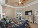 Relaxing main bedroom featuring tray ceilings, access to outdoor patio, and a comfortable seating area at 12136 Se 176Th Loop, Summerfield, FL 34491
