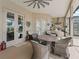 Covered patio with table, wicker chairs, ceiling fan, and built-in kitchen at 12136 Se 176Th Loop, Summerfield, FL 34491