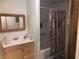Functional bathroom with a vanity sink, mirror, and a shower-tub combo, ideal for everyday use at 136 S Commercial St, Coleman, FL 33521