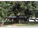 Charming single-story home with mature trees and fenced yard, offering a serene and private setting at 136 S Commercial St, Coleman, FL 33521