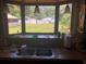 Kitchen sink window offers a view of the backyard and garden at 136 S Commercial St, Coleman, FL 33521