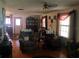 Cozy living room with hardwood floors, recliner seating, and classic decor, creating a welcoming atmosphere at 136 S Commercial St, Coleman, FL 33521