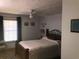 Cozy bedroom featuring a queen-sized bed, natural light, and comfortable area rugs, creating a peaceful ambiance at 136 S Commercial St, Coleman, FL 33521